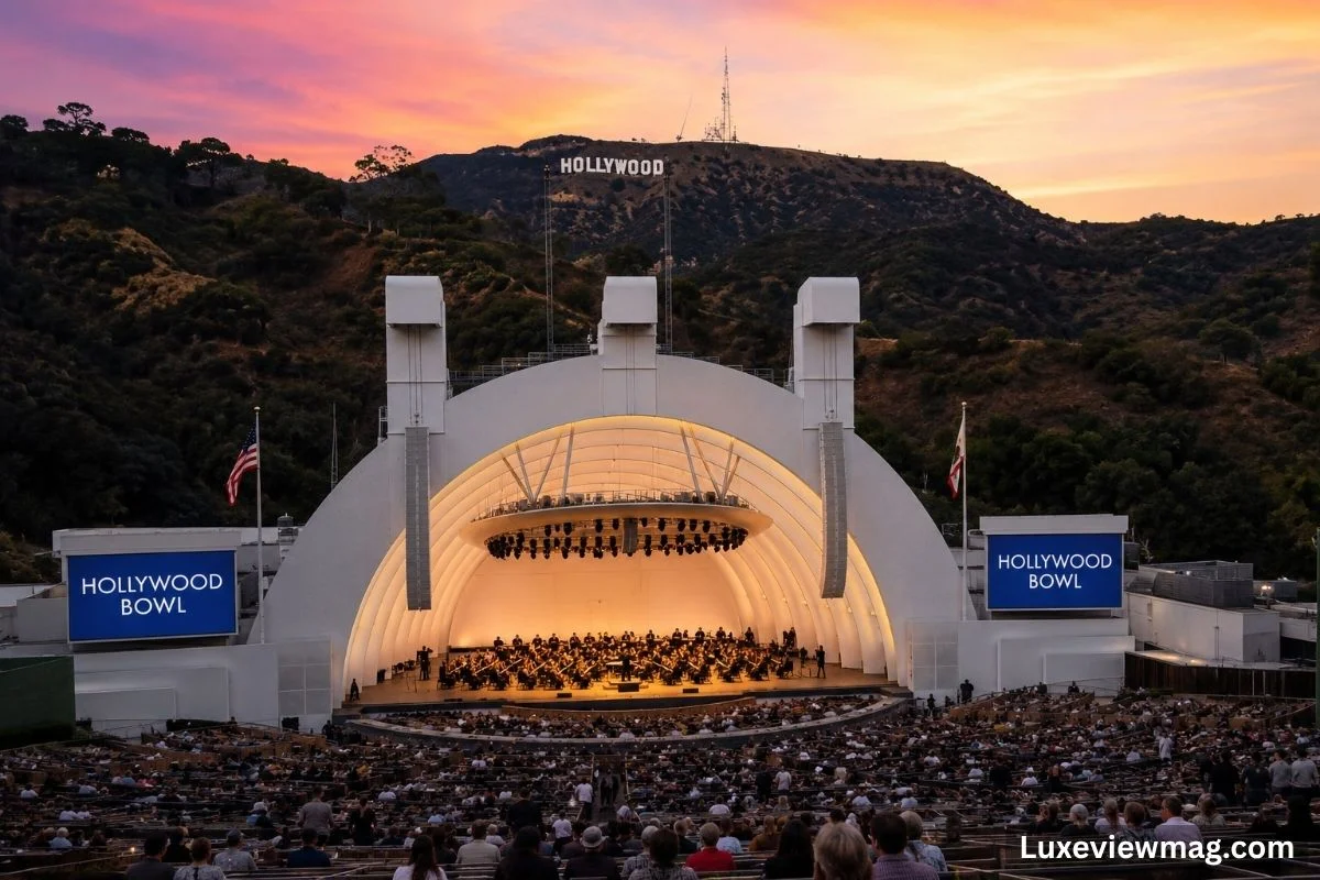 A vibrant concert at the Hollywood Bowl, featuring a large audience enjoying a live performance under the night sky.