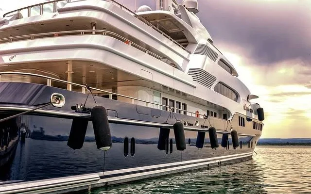 A grand yacht rests at a dock in italy luxury yacht dry drowning​and sophistication against the tranquil waters surrounding it.