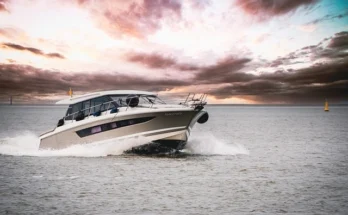 A motorboat moves through the water, illustrating the architectural details of the lady moura yacht sectional drawing in a sectional.