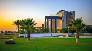A modern luxury villas italy le collectionist, framed by palm trees, showcasing elegant architecture and a serene atmosphere.