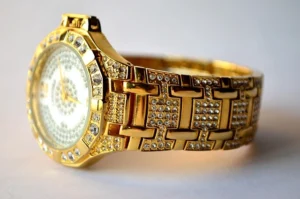 A luxurious Bugatti watch with a gold band and diamond embellishments on the face, exuding elegance and sophistication.