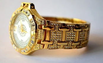 A luxurious Bugatti watch with a gold band and diamond embellishments on the face, exuding elegance and sophistication.