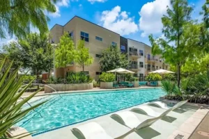 The tranquil pool area at Yorktown Luxury Apartments, featuring clear water and landscaped surroundings for leisure activities.