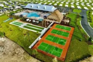 Tennis court and pool at Champions Run Luxury RV Resort, showcasing recreational amenities for guests.