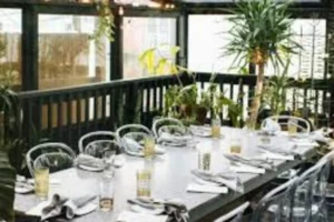 Long bar area at Rose's Luxury DC, featuring a stylish design and ample seating for patrons.
