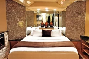 A luxurious bedroom featuring a bed and a mirror, showcasing the elegance of the Champagne Lodge & Luxury Suites.