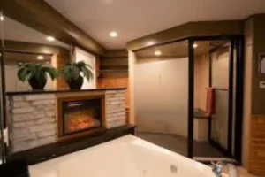 Luxurious bathroom with a fireplace and a stylish tub, highlighting the opulence of the Champagne Lodge Executive Suites.