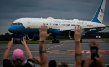 Individuals stand with hands up before a luxury jet, while trump tries to defend using luxury jet from qatar​.