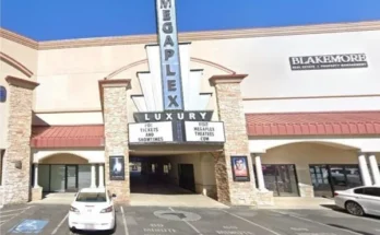 Exterior view of the megaplex luxury theatres at cottonwood​, featuring a parking lot and modern architectural design.