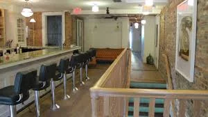 Long bar area at rose's luxury dc Upstairs Bar, featuring a stylish design and ample seating for patrons.