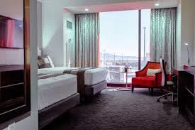 Ahern luxury boutique hotel room featuring two beds, a television, and a desk in an elegant setting.