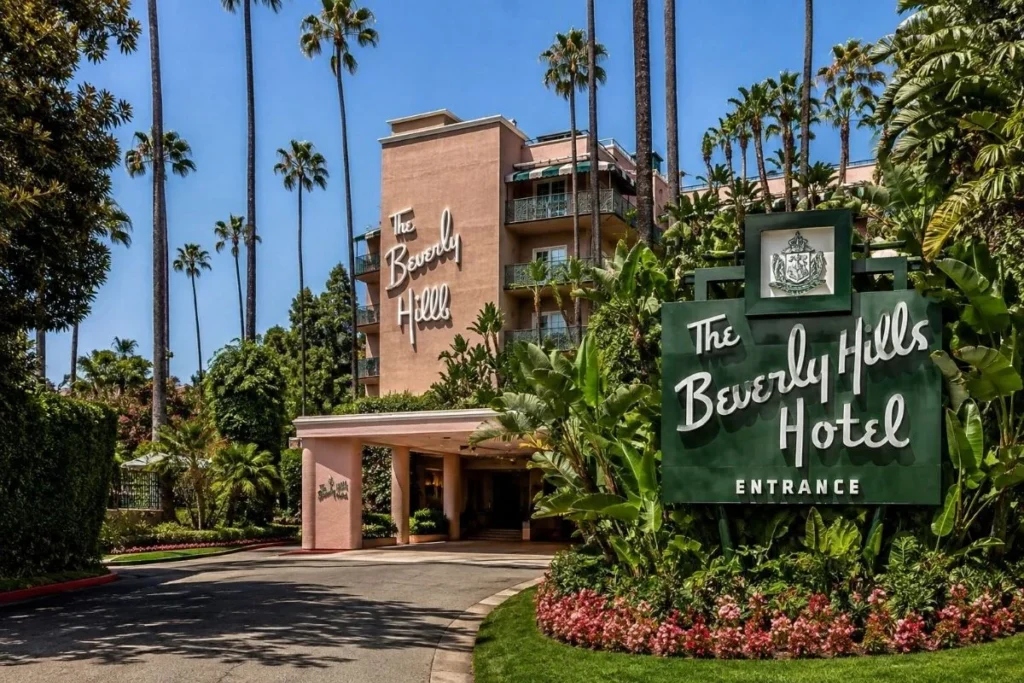 The Beverly Hills Hotel exterior with palm trees, tropical gardens, and iconic pink architecture