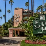 The Beverly Hills Hotel exterior with palm trees, tropical gardens, and iconic pink architecture
