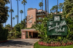 The Beverly Hills Hotel exterior with palm trees, tropical gardens, and iconic pink architecture