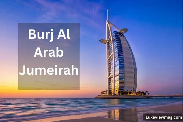 Burj Al Arab Jumeirah luxury hotel overlooking the Arabian Gulf at sunset in Dubai.