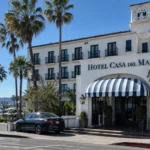 Hotel Casa del Mar exterior with palm trees and ocean view in Santa Monica.