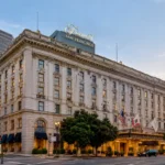 The Fairmont San Francisco hotel, featuring its grand facade and iconic entrance amidst the urban landscape.