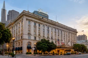 The Fairmont San Francisco hotel, featuring its grand facade and iconic entrance amidst the urban landscape.