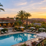 Rancho Valencia Resort & Spa luxury resort with swimming pool, Mediterranean-style villas, palm trees, and sunset views in California.